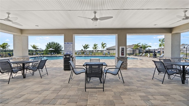 2220 Chris Dr, Winter Haven, FL 33884 - view of patio with a ceiling fan, outdoor dining area, and a community pool