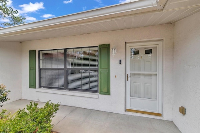 7120 N Glenridge Cir, Citrus Springs, FL 34434 - doorway to property with stucco siding