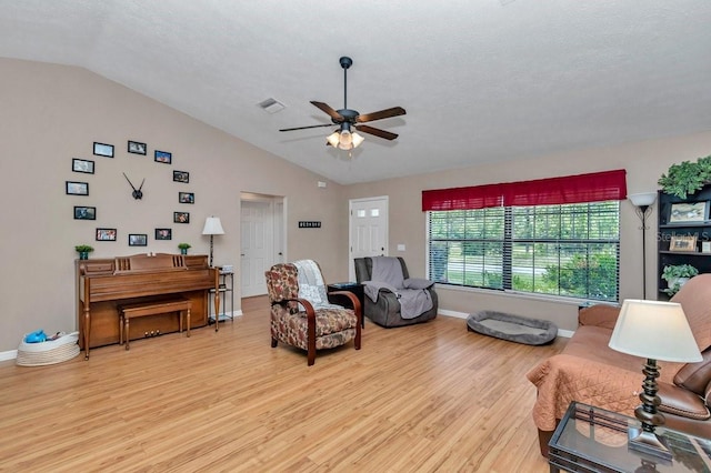 7120 N Glenridge Cir, Citrus Springs, FL 34434 - living area with lofted ceiling, a ceiling fan, light wood-style floors, and a textured ceiling
