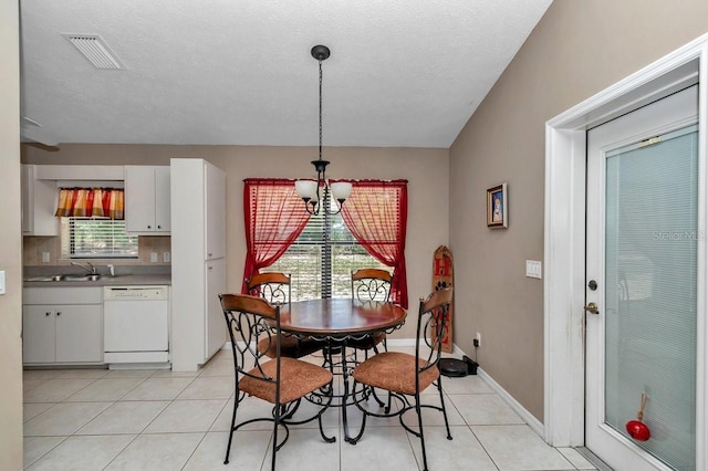 7120 N Glenridge Cir, Citrus Springs, FL 34434 - dining room with a chandelier, light tile patterned flooring, and a textured ceiling