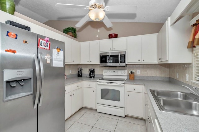 7120 N Glenridge Cir, Citrus Springs, FL 34434 - kitchen featuring stainless steel appliances, vaulted ceiling, light tile patterned floors, ceiling fan, and backsplash