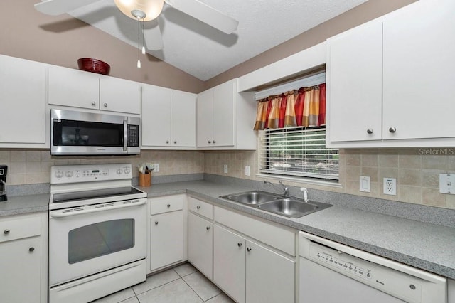 7120 N Glenridge Cir, Citrus Springs, FL 34434 - kitchen with white appliances, lofted ceiling, white cabinets, backsplash, and light countertops