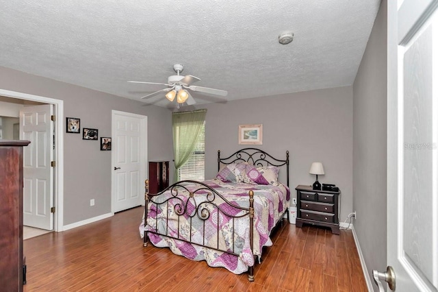 7120 N Glenridge Cir, Citrus Springs, FL 34434 - bedroom with wood finished floors, ceiling fan, and a textured ceiling