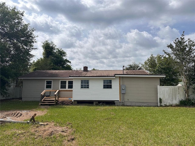 4274 2nd Ave, Marianna, FL 32446 - back of house featuring a metal roof and a chimney