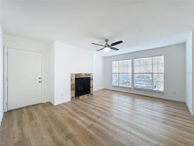645 Stafford Ter Unit 163, Altamonte Springs, FL 32714 - unfurnished living room with a tiled fireplace, light wood-type flooring, and ceiling fan