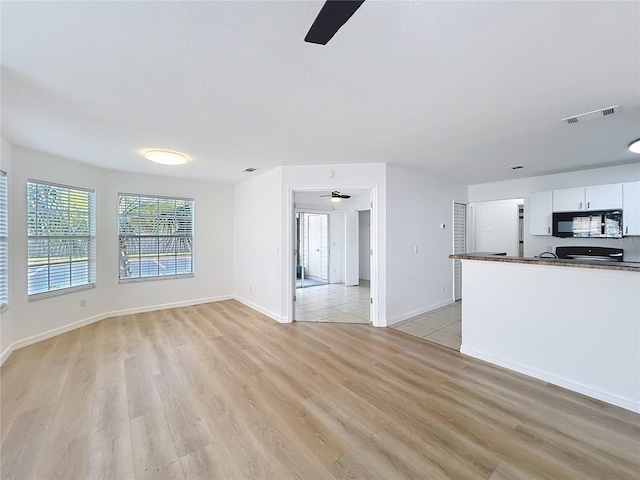 645 Stafford Ter Unit 163, Altamonte Springs, FL 32714 - unfurnished living room featuring a ceiling fan and light wood-style flooring