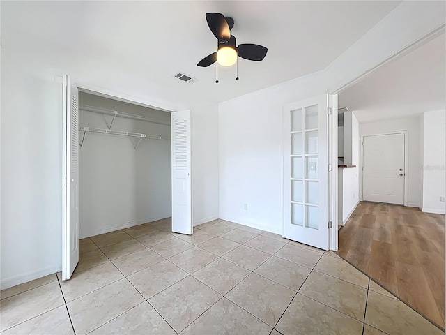 645 Stafford Ter Unit 163, Altamonte Springs, FL 32714 - unfurnished bedroom featuring light tile patterned floors, a closet, and ceiling fan