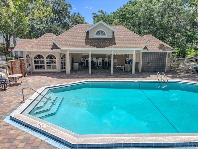 645 Stafford Ter Unit 163, Altamonte Springs, FL 32714 - community pool with an exterior structure, a patio, and an outbuilding
