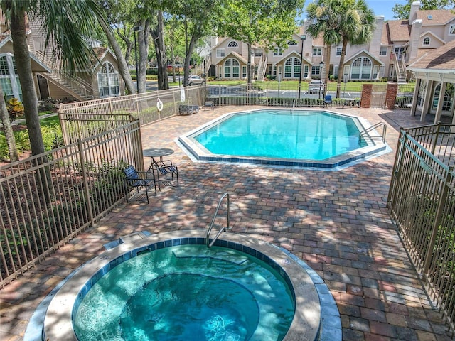 645 Stafford Ter Unit 163, Altamonte Springs, FL 32714 - community pool featuring a community hot tub, a patio, and a residential view
