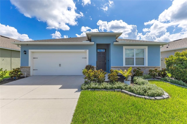 633 Greymount St, Davenport, FL 33837 - view of front facade featuring stone siding, stucco siding, a garage, driveway, and a front lawn