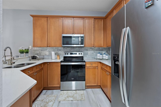 6027 Strada Isle Way, Orlando, FL 32835 - kitchen with appliances with stainless steel finishes, backsplash, and brown cabinets