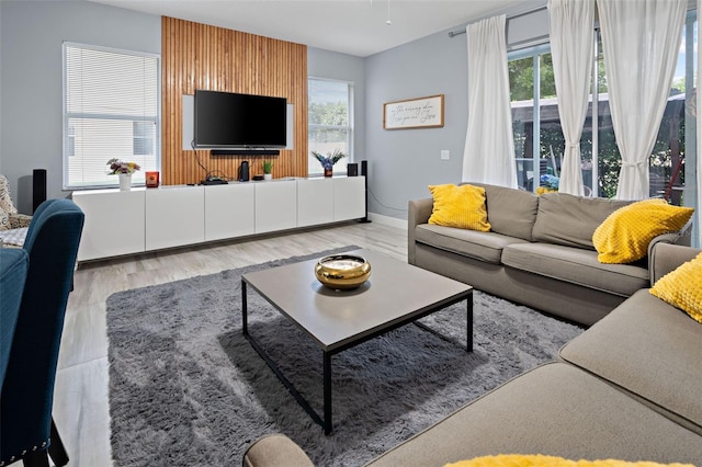 6027 Strada Isle Way, Orlando, FL 32835 - living room featuring plenty of natural light and wood finished floors