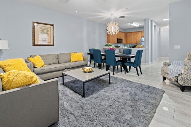 6027 Strada Isle Way, Orlando, FL 32835 - living room featuring a chandelier and baseboards