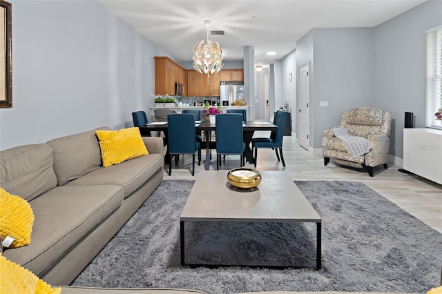 6027 Strada Isle Way, Orlando, FL 32835 - living area with a chandelier, light wood finished floors, and recessed lighting