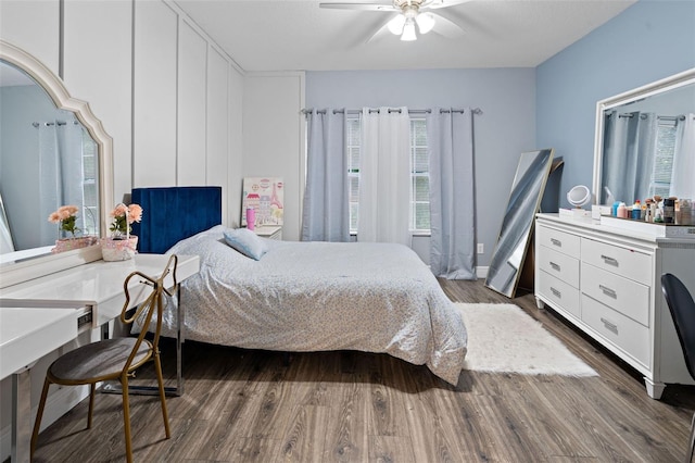 6027 Strada Isle Way, Orlando, FL 32835 - bedroom featuring dark wood-style flooring and a ceiling fan