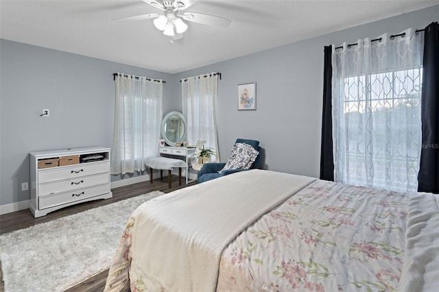 6027 Strada Isle Way, Orlando, FL 32835 - bedroom featuring dark wood-style floors and a ceiling fan