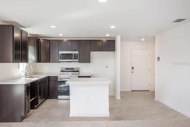 230 Locus Pass Crse, Ocala, FL 34472 - kitchen featuring appliances with stainless steel finishes, dark brown cabinets, recessed lighting, a kitchen island, and light countertops