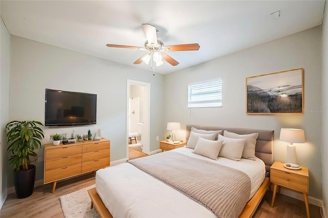 4559 W Gore Ave, Orlando, FL 32811 - bedroom featuring light wood-style floors, ceiling fan, and ensuite bathroom