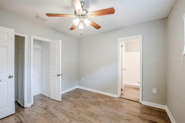 4559 W Gore Ave, Orlando, FL 32811 - unfurnished bedroom with light wood-style flooring, ensuite bathroom, a ceiling fan, and a closet
