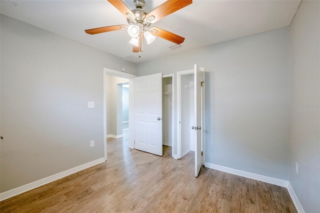 4559 W Gore Ave, Orlando, FL 32811 - unfurnished bedroom featuring light wood-style floors, a ceiling fan, and a closet