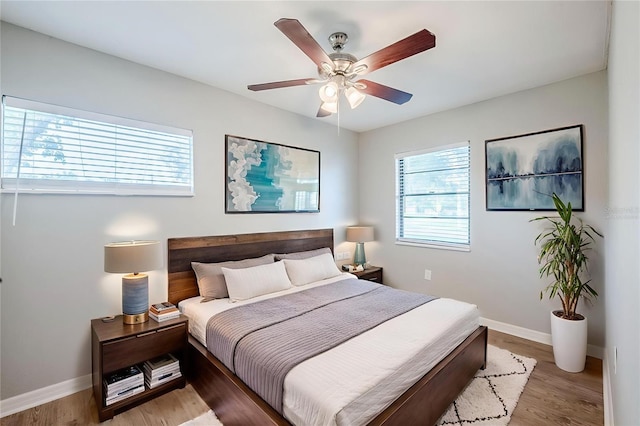 4559 W Gore Ave, Orlando, FL 32811 - bedroom featuring multiple windows, wood finished floors, and a ceiling fan