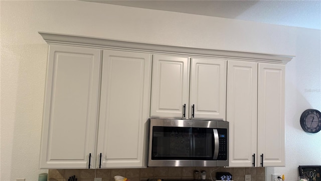 506 Mirasol Cir Unit 202, Celebration, FL 34747 - kitchen view of stainless steel microwave and white cabinets