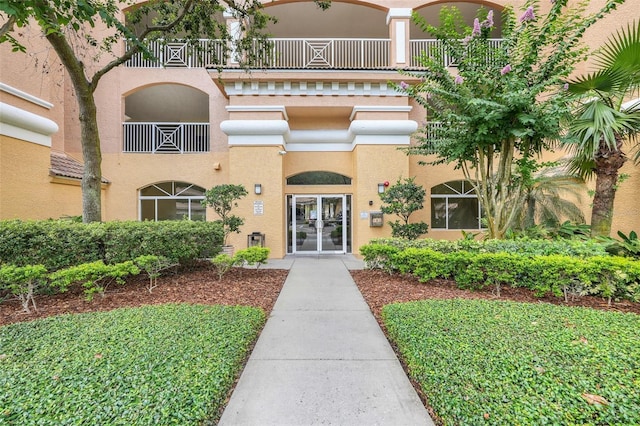 6336 Buford St Unit 209, Orlando, FL 32835 - property entrance featuring a balcony, stucco siding, and french doors