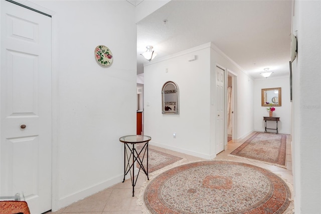 6336 Buford St Unit 209, Orlando, FL 32835 - hall featuring inlaid floor details, crown molding, and light tile patterned floors