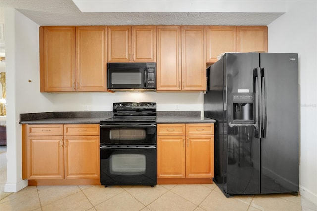 6336 Buford St Unit 209, Orlando, FL 32835 - kitchen featuring black appliances, dark countertops, and light tile patterned floors