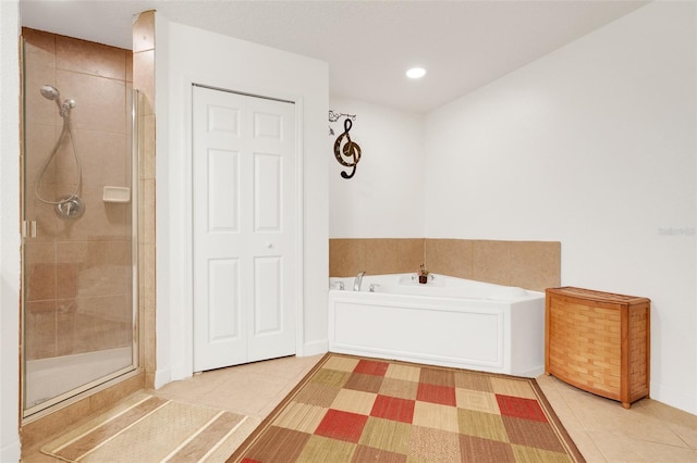 6336 Buford St Unit 209, Orlando, FL 32835 - full bathroom featuring tile patterned floors, a shower stall, a bath, and recessed lighting