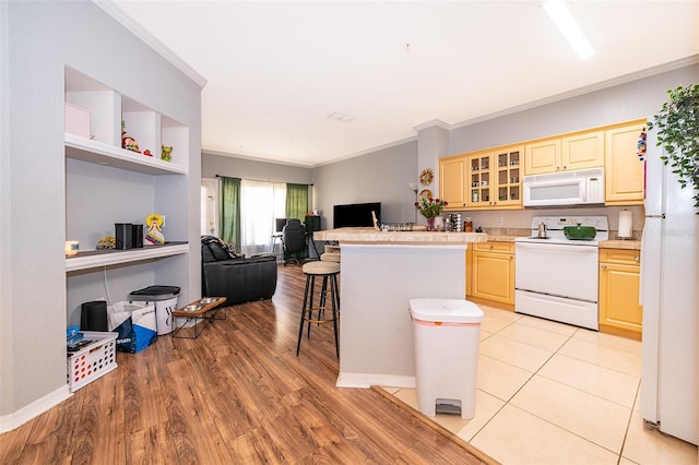 3707 Conroy Rd Unit 1715, Orlando, FL 32839 - kitchen with white appliances, ornamental molding, open floor plan, light countertops, and a kitchen breakfast bar