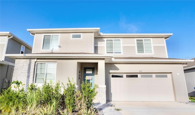 1023 Sugarwood St, Davenport, FL 33837 - view of front of home featuring an attached garage, concrete driveway, brick siding, and stucco siding