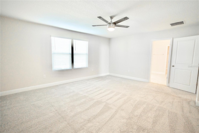 1023 Sugarwood St, Davenport, FL 33837 - unfurnished bedroom with light colored carpet, ensuite bathroom, and a ceiling fan