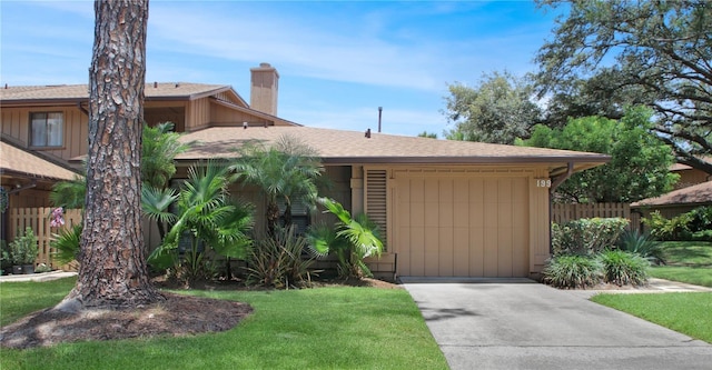 199 Heron Bay Cir, Lake Mary, FL 32746 - view of front of property featuring concrete driveway, a garage, a chimney, and a shingled roof