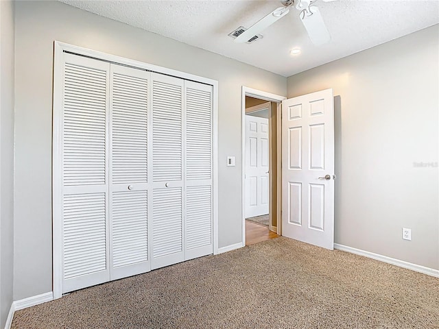 2641 Delcrest Dr, Orlando, FL 32817 - unfurnished bedroom featuring a closet, carpet, a ceiling fan, and a textured ceiling