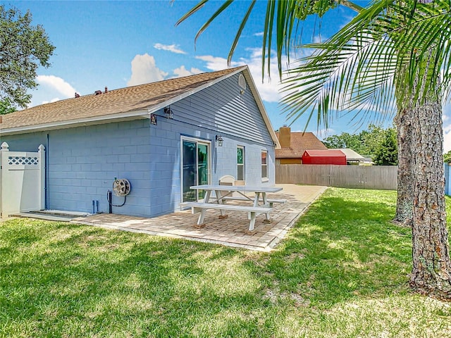 2641 Delcrest Dr, Orlando, FL 32817 - rear view of house with a fenced backyard, a patio, and roof with shingles