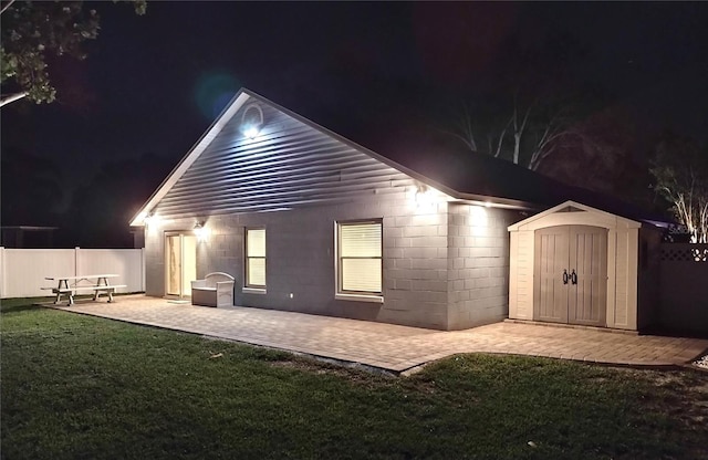 2641 Delcrest Dr, Orlando, FL 32817 - back of house at twilight featuring a shed and a patio