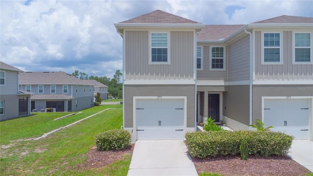 275 Blueberry Ln, Davenport, FL 33837 - townhome / multi-family property featuring a garage, a front yard, board and batten siding, and driveway