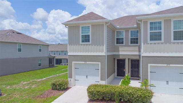 275 Blueberry Ln, Davenport, FL 33837 - townhome / multi-family property featuring an attached garage, board and batten siding, a front yard, and a shingled roof