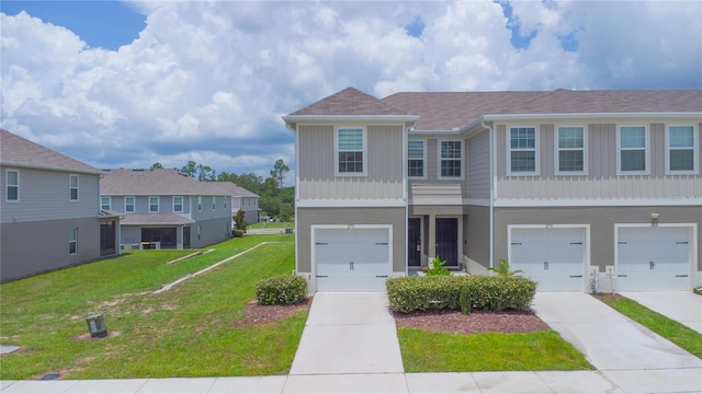 275 Blueberry Ln, Davenport, FL 33837 - townhome / multi-family property with concrete driveway, a front yard, an attached garage, and a residential view