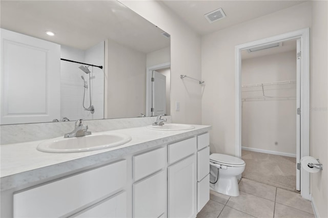 275 Blueberry Ln, Davenport, FL 33837 - bathroom featuring double vanity, tile patterned flooring, a walk in closet, a shower, and recessed lighting