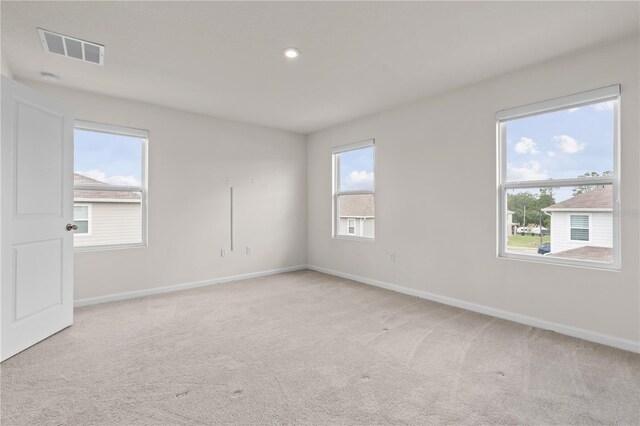 275 Blueberry Ln, Davenport, FL 33837 - spare room featuring light carpet and recessed lighting