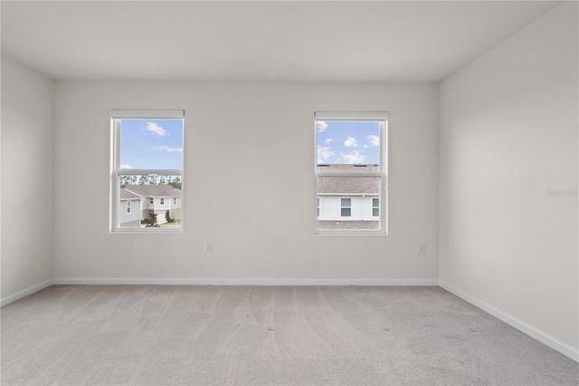 275 Blueberry Ln, Davenport, FL 33837 - unfurnished room with light carpet and healthy amount of natural light