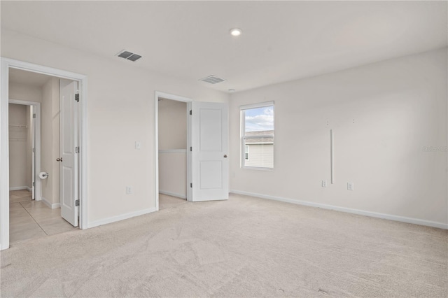 275 Blueberry Ln, Davenport, FL 33837 - unfurnished bedroom featuring light colored carpet, a spacious closet, and recessed lighting