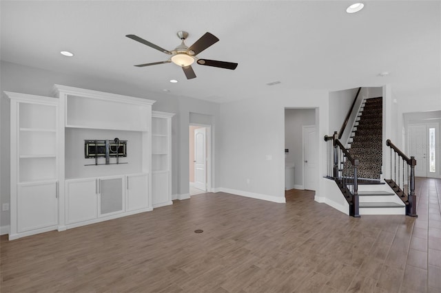 32004 Redtail Reserve Blvd, Sorrento, FL 32776 - unfurnished living room featuring a ceiling fan, stairs, wood finished floors, and recessed lighting