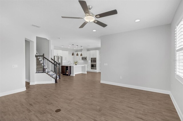32004 Redtail Reserve Blvd, Sorrento, FL 32776 - unfurnished living room with a ceiling fan, stairway, recessed lighting, and wood finished floors