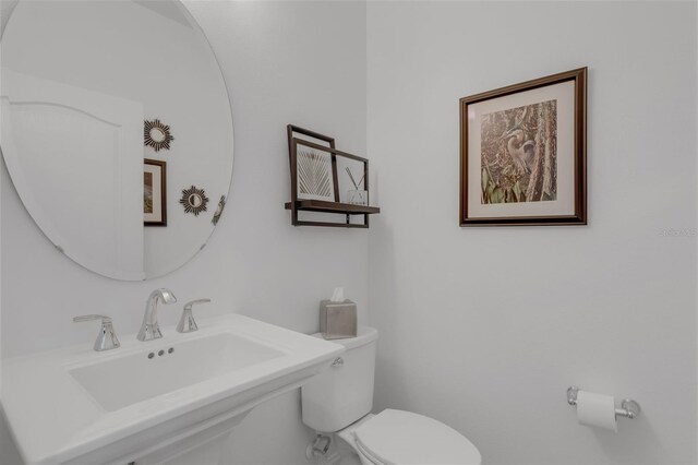 32004 Redtail Reserve Blvd, Sorrento, FL 32776 - half bathroom featuring toilet and a sink