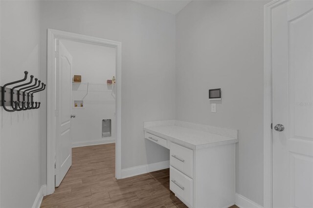32004 Redtail Reserve Blvd, Sorrento, FL 32776 - laundry room featuring hookup for a washing machine, light wood-style flooring, and a desk