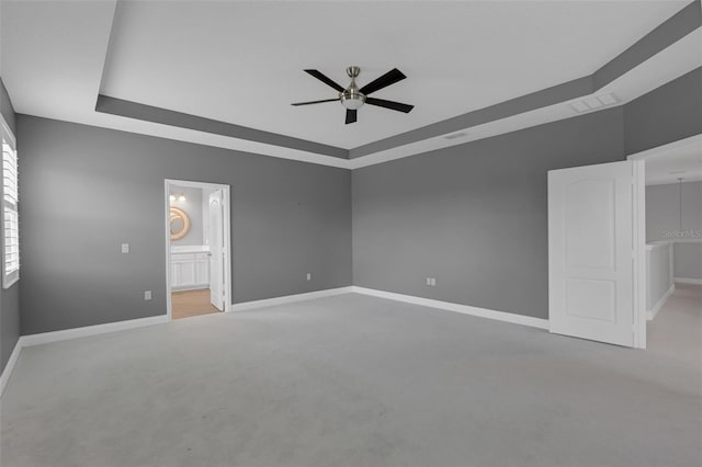 32004 Redtail Reserve Blvd, Sorrento, FL 32776 - unfurnished bedroom featuring a raised ceiling, ensuite bathroom, carpet, and a ceiling fan