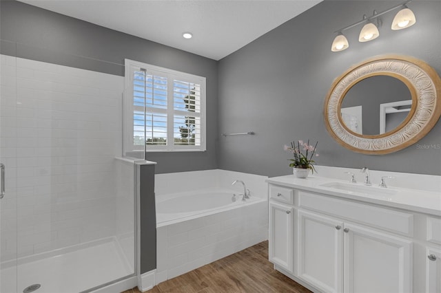 32004 Redtail Reserve Blvd, Sorrento, FL 32776 - full bathroom featuring wood finished floors, vanity, a bath, and a tile shower